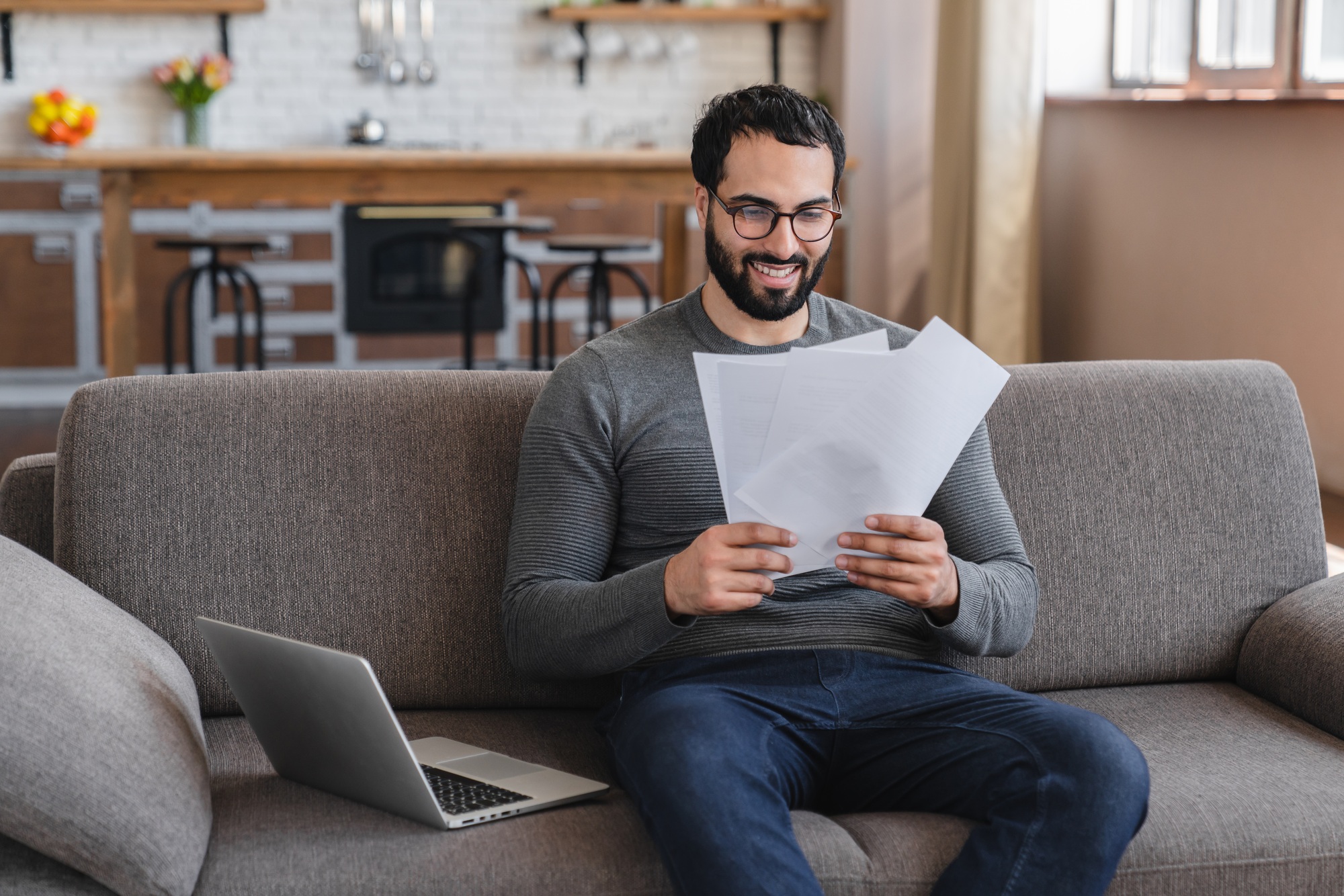 Excited Arabian man holding document, paper notification, job promotion, loan approval