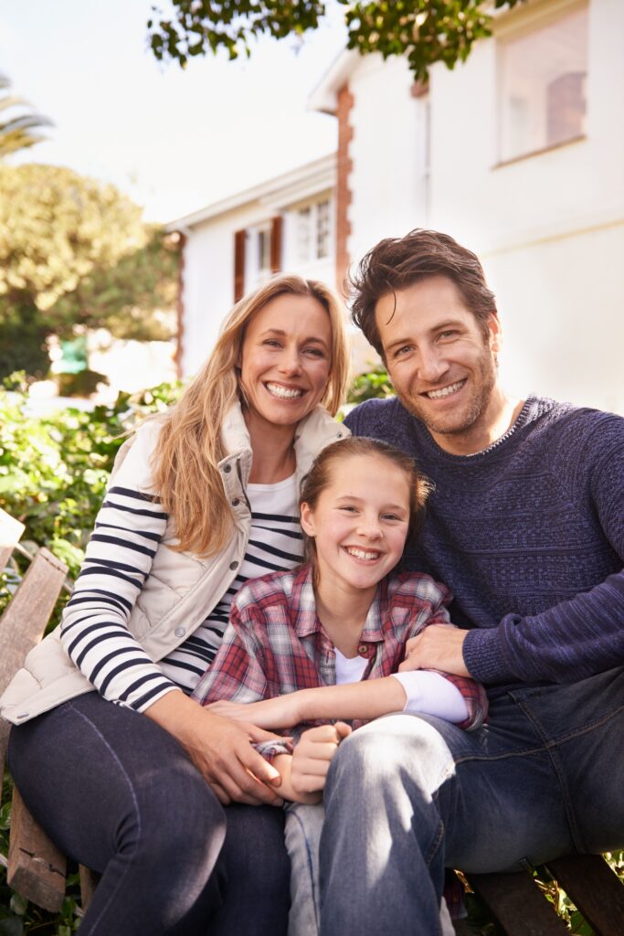 Family time at home. A portrait of a happy family posing outside their home.